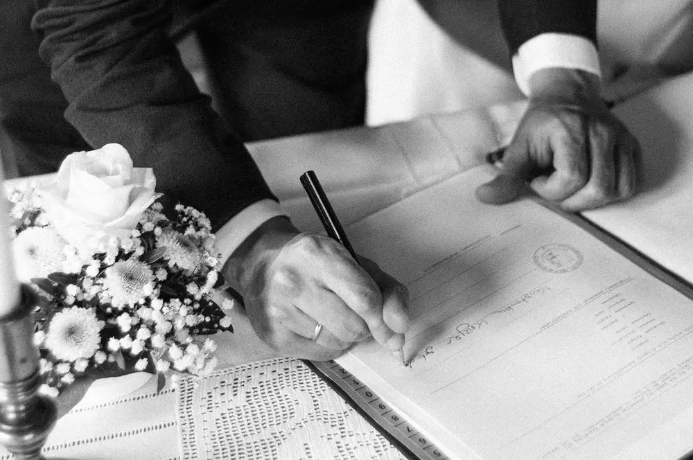 Civil ceremony at Museum Landschaft Eiderstedt. Groom signing. Leica M10 M11.